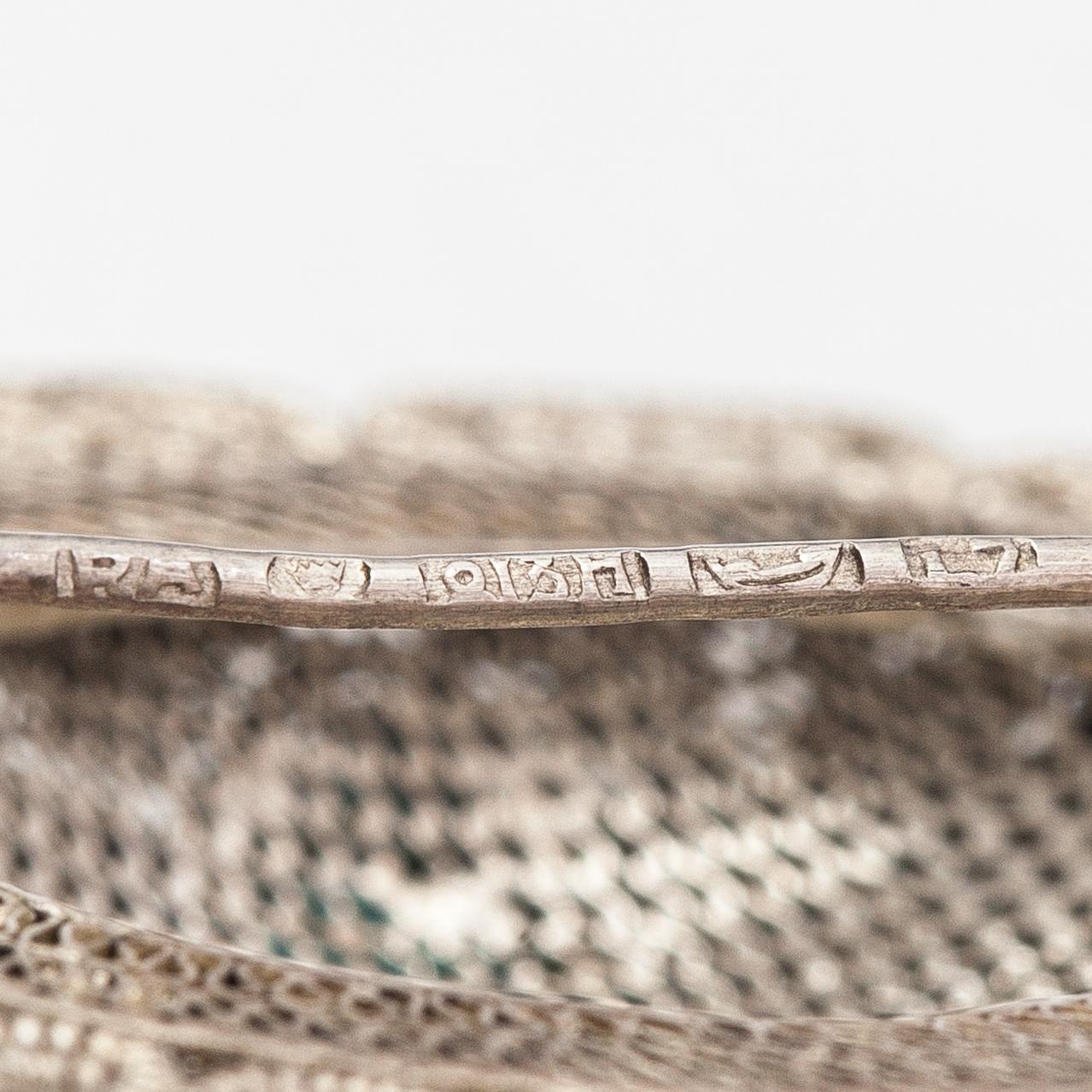 A silver bracelet and ring with turquoises. China.