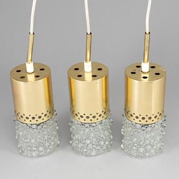 Three brass and glass pendant lights, 1960's.