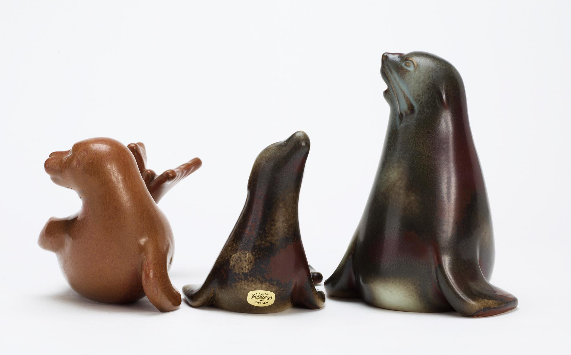 Three Gunnar Nylund stoneware figures of seals, Rörstrand.