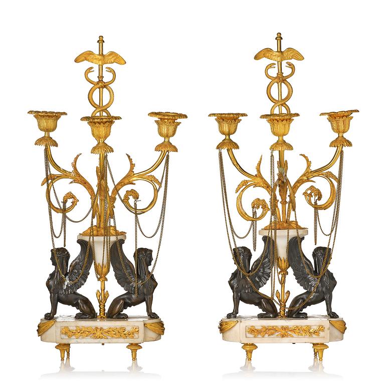 A pair of Louis XVI three lights Candelabra, Parisian works, in the manner of François Rémond, late 18th century.