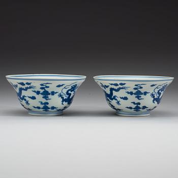 A pair of blue and white five clawed dragon bowls, Qing dynasty with Qianlong's sealmark and period (1736-95).