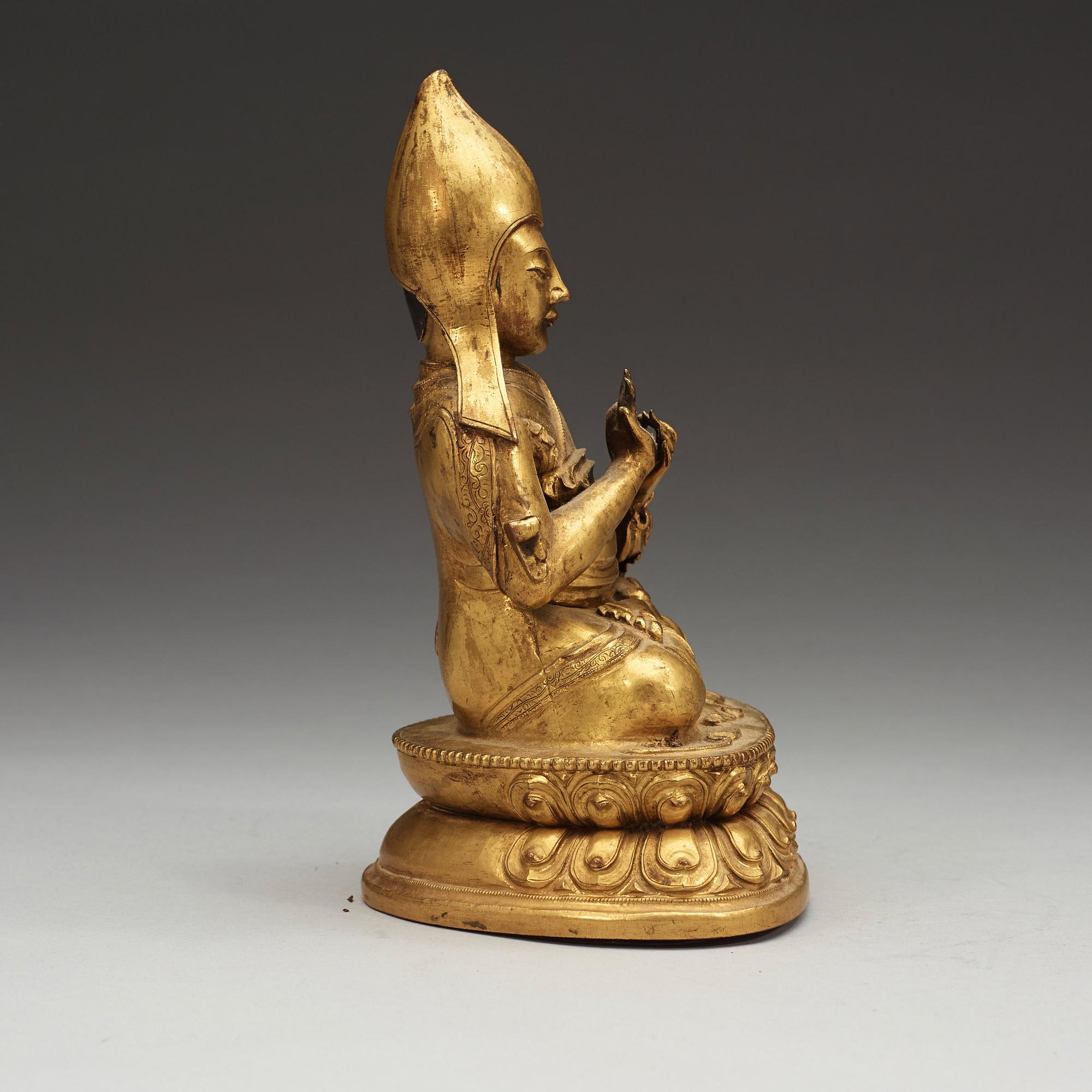 A Sino-Tibetan gilt copper alloy repoussé figure of Tsong Khapa, 18/19th Century.