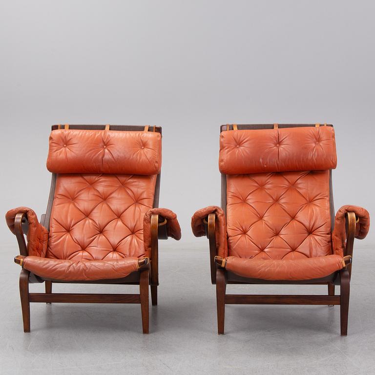 An end of the 20th Century pair of 'Pernilla' easy chairs with leather upholstery by Bruno Mathsson for DUX.