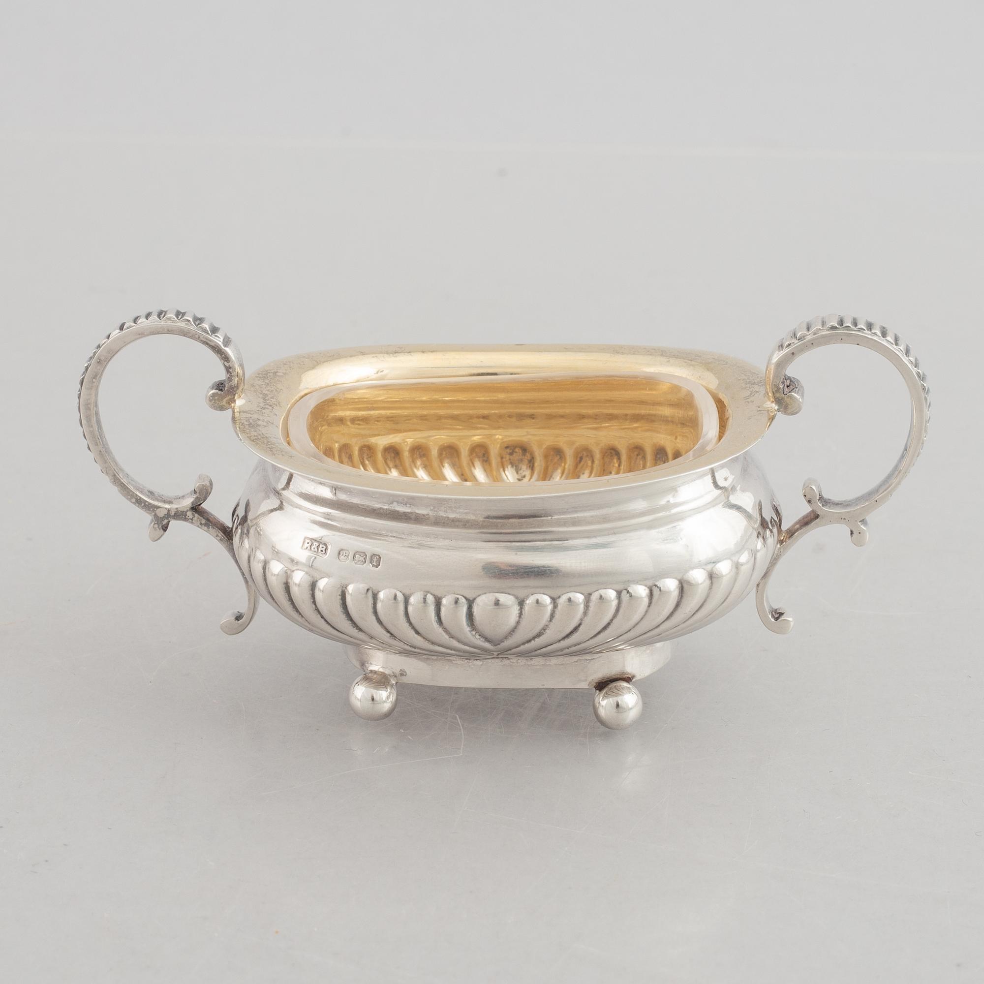 A set of four English silver salt cellars and a toast rack, including Roberts & Belk, Sheffield, England 1898.