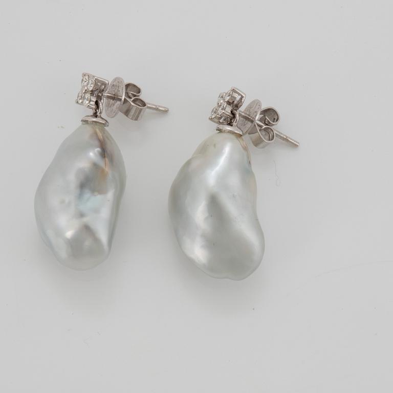 A pair of cultured South Sea pearl earrings in 18K white gold set with round brilliant-cut diamonds.