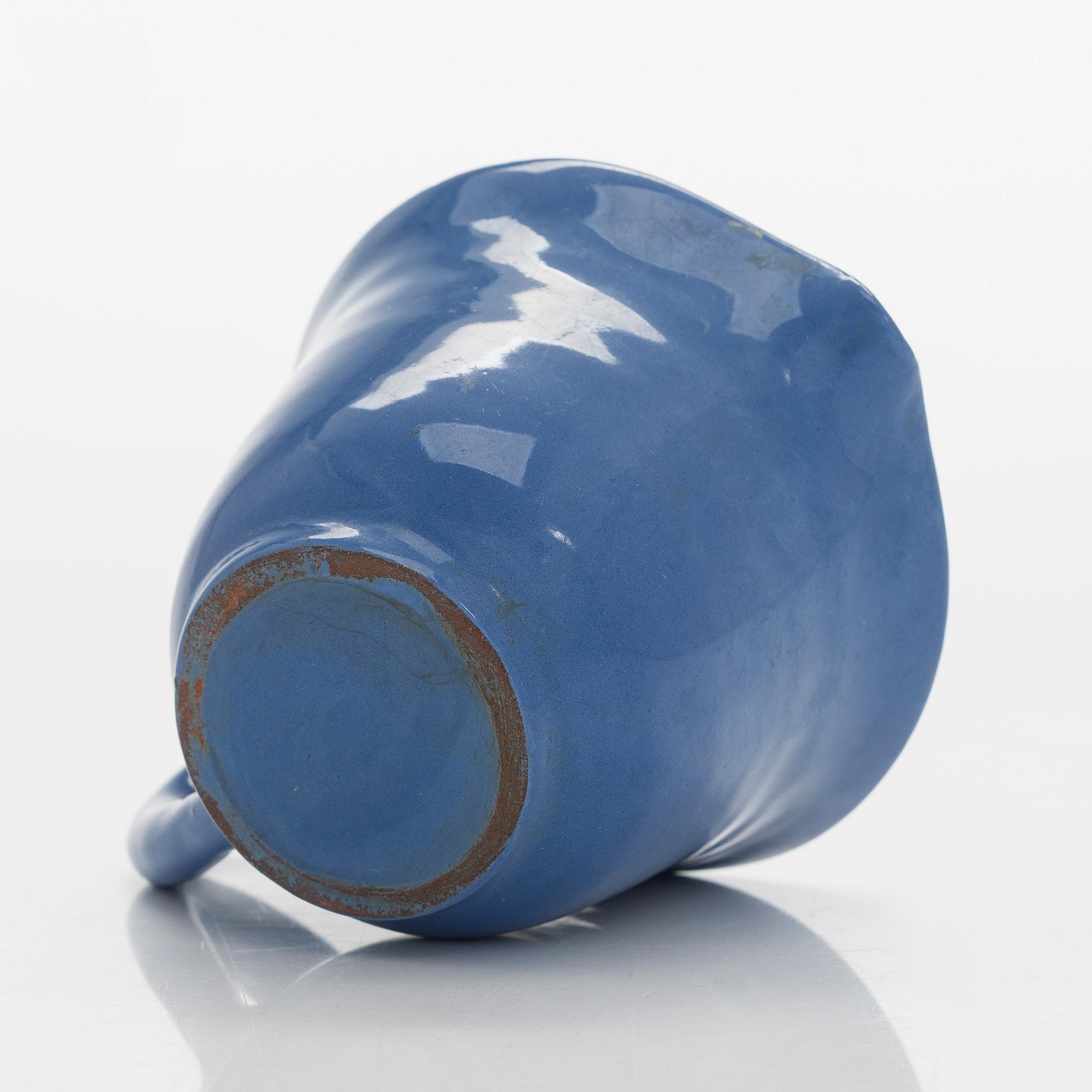 Marita Lybeck, a set of three ceramic plates and cream jug, red clay, signed ML.