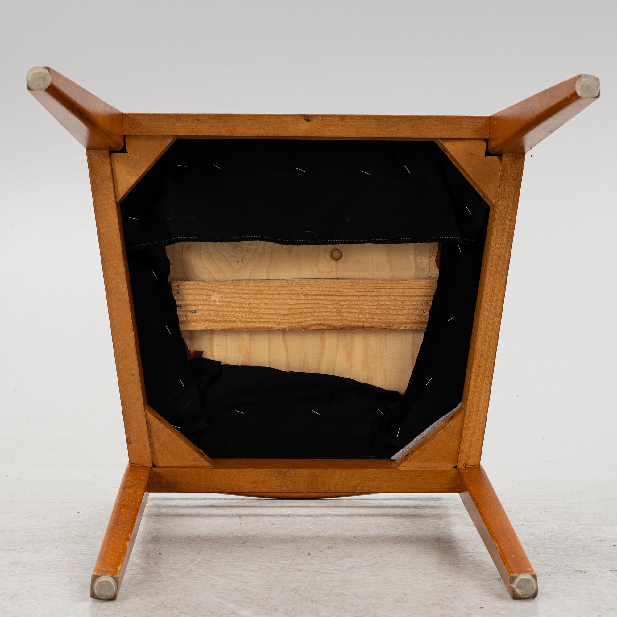 A dining table with four chairs, mid 20th century.