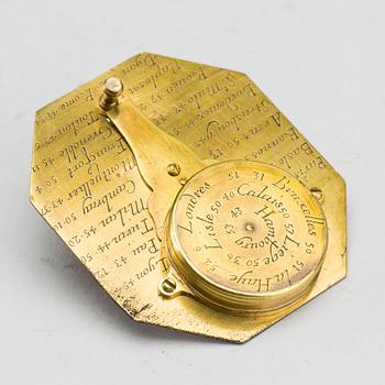 A brass travel sundial marked Le Maire et Fils Paris around 1700.