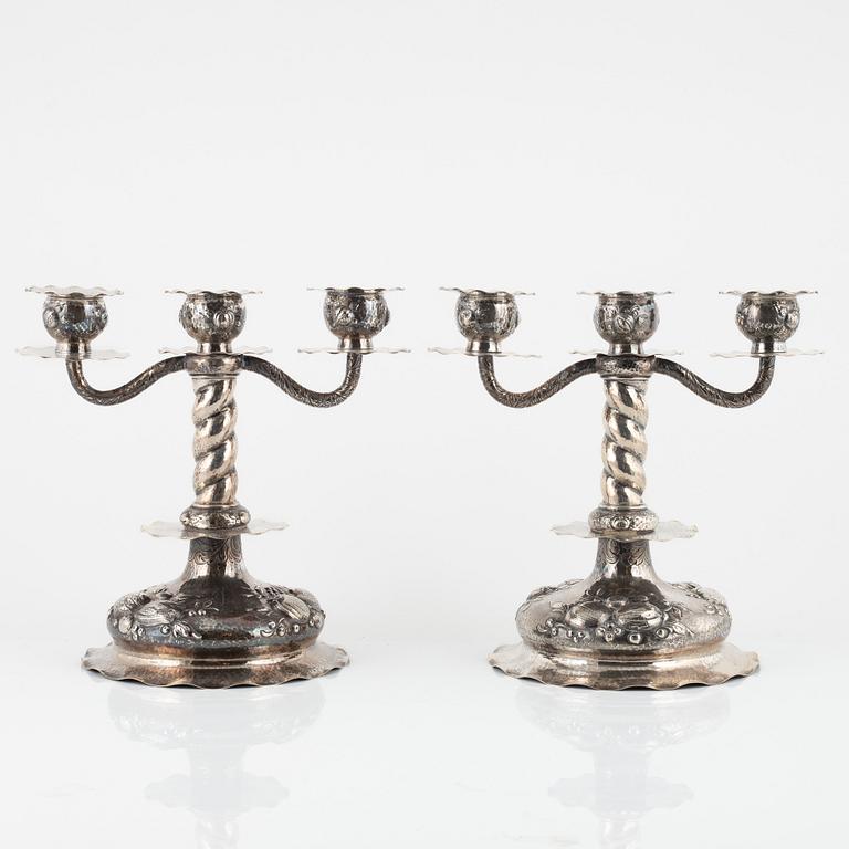 A pair of Baroque style silver candelabras, bearing the mark of CG Hallberg, Stockholm, 1928.