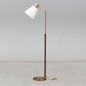 a brass and leather floor lamp from the second half of the 20th century.