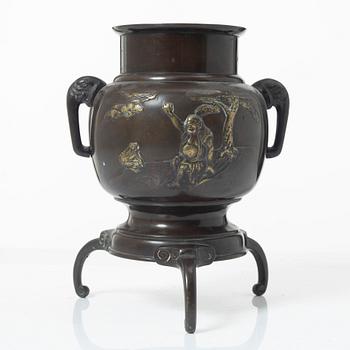 A Japanese bronze tripod vase, Meiji period (1868-1912).