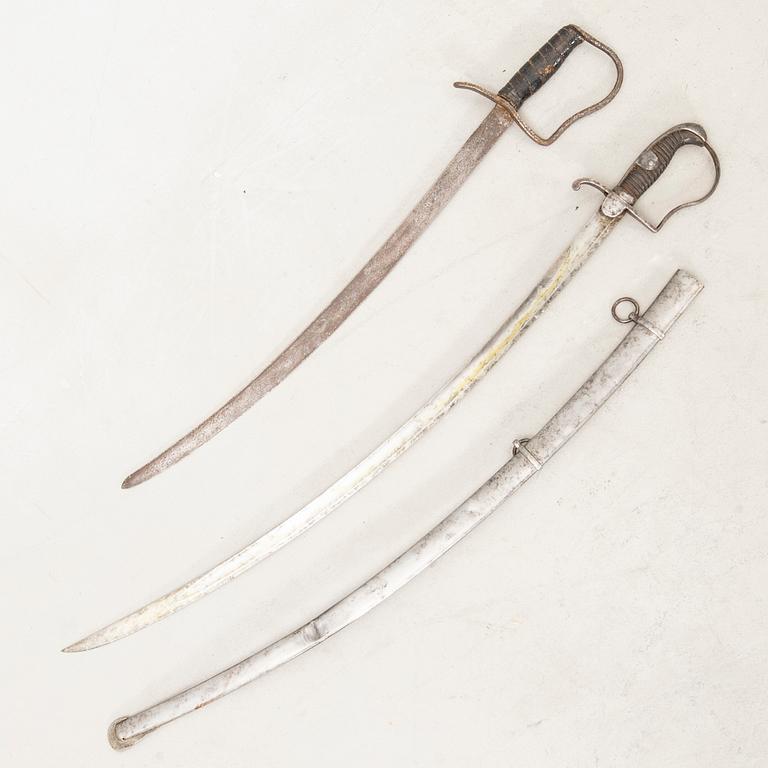 A German sabre with scabbard and a cutlass.