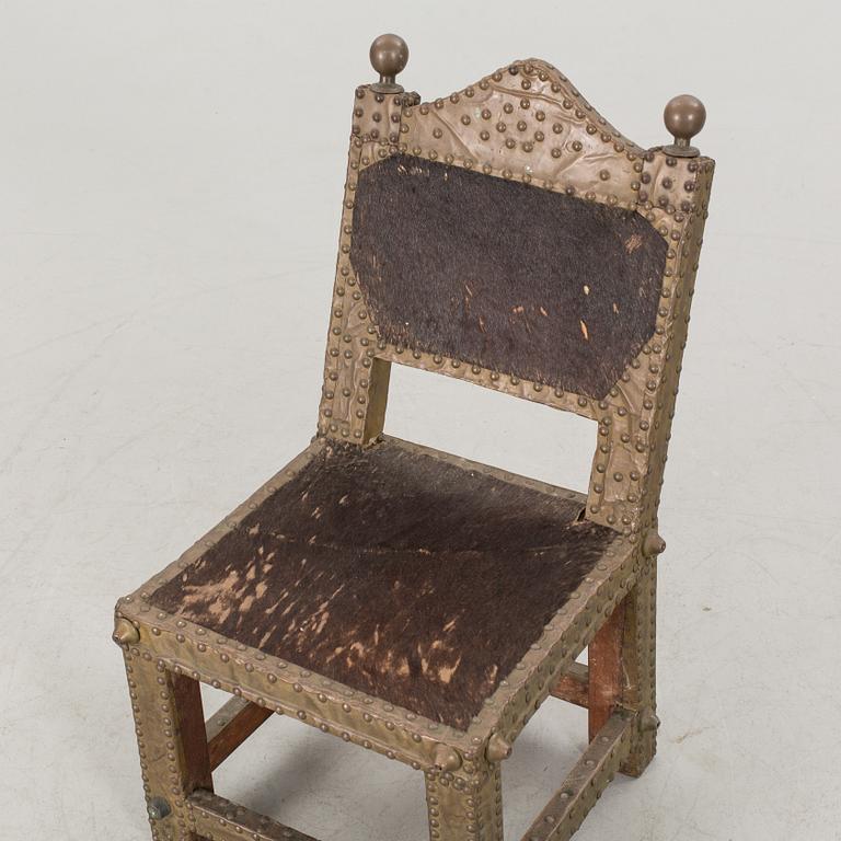 An Ashanti chair, Ghana, hardwood with brass studs, ca 1900.