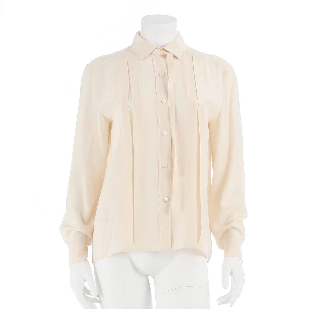 CÉLINE, a créme colored silk blouse.
