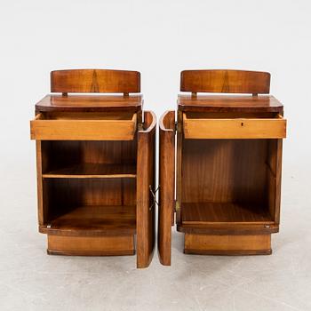 A pair of lacquered walnut bedside tables from the first half of the 20th cenutry.