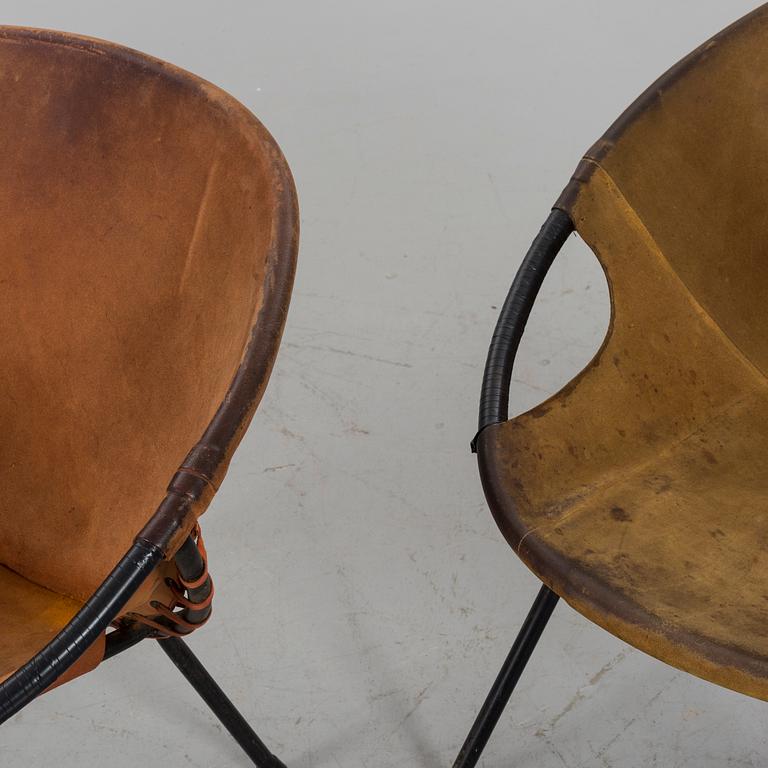 A pair of 1960s-70s steel and leather easy chairs.