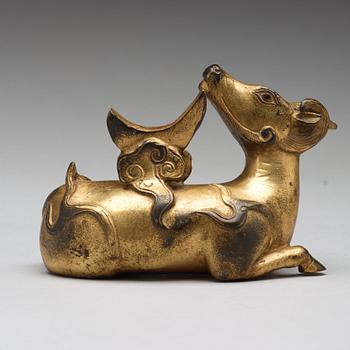 A gilt bronze figure of a reclining mythical animal, Qing dynasty, 19th Century.