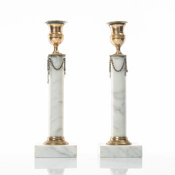 A pair of gilt-brass and marble late Gustavians candlesticks, late 18th century.