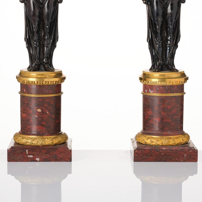 A pair of Louis XVI ormolu and patinated bronze six-branch candelabra attributed to François Rémond, late 18th century.