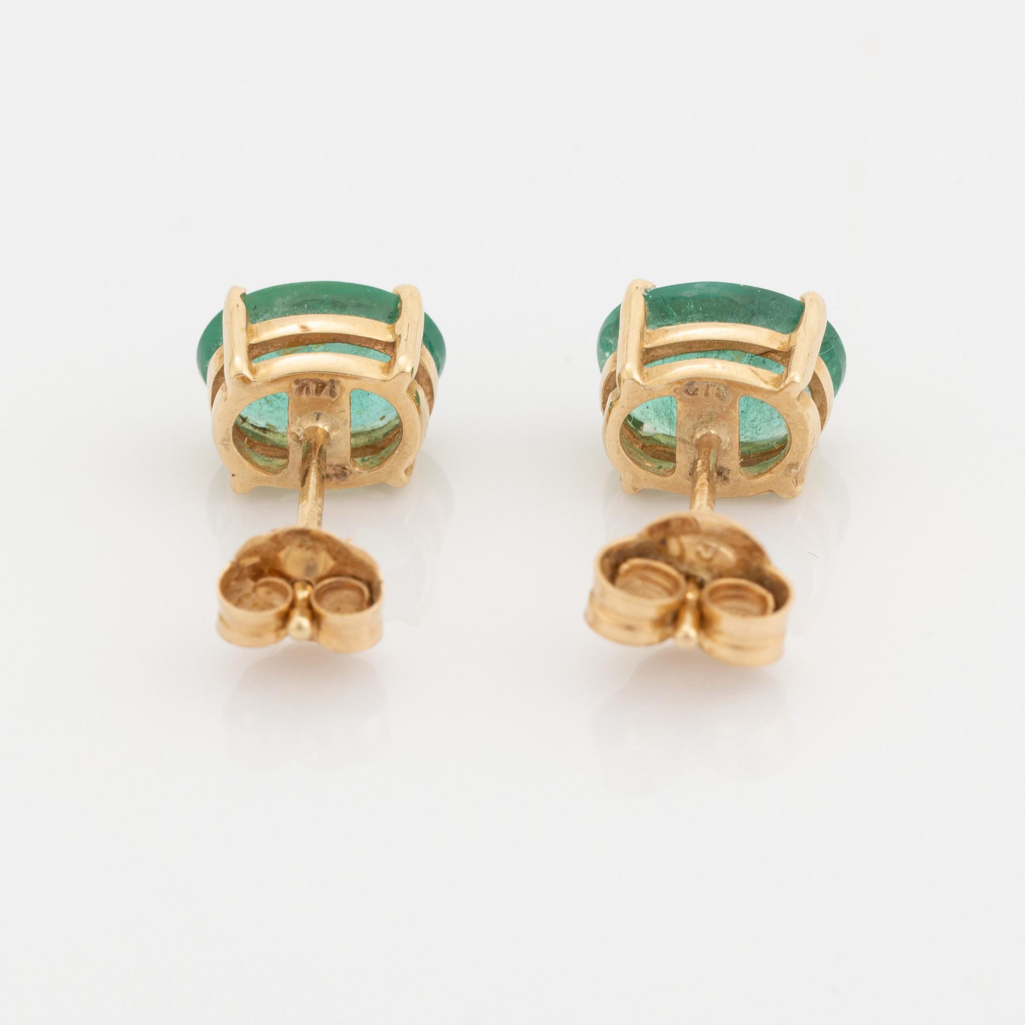 Gold and oval emerald earrings.
