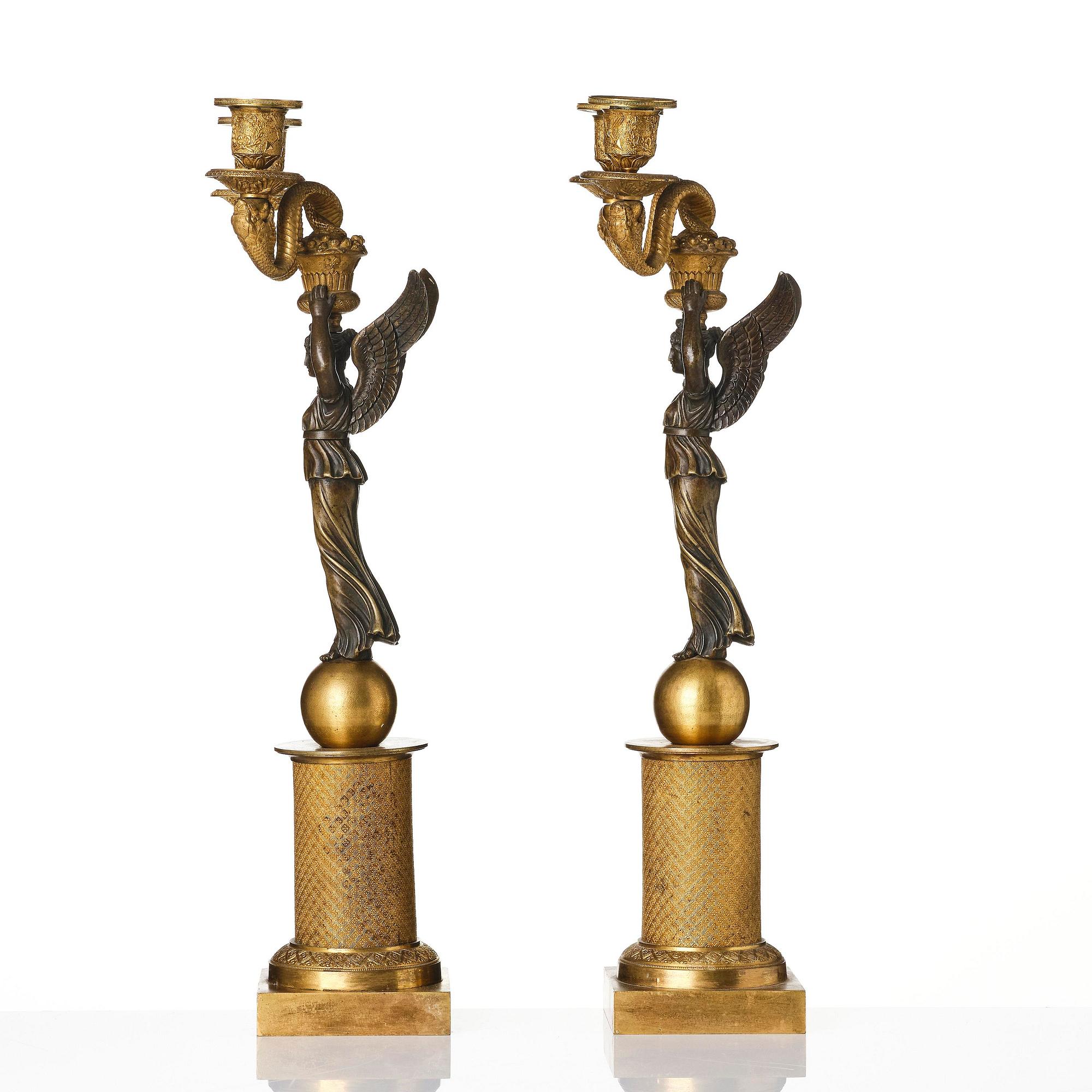 A pair of gilt and patinated bronze Empire-style two branch candelabra, later part 18th century.