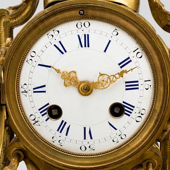 A table CLOCK and a pair of candelabra, second part of 19th century.