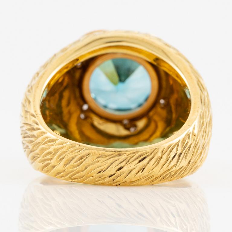 A ring in 18K gold with a blue faceted zircon and eight-cut diamonds.