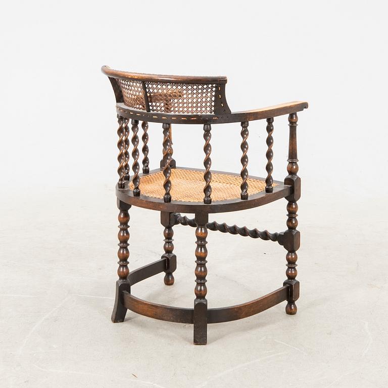 A rattan and wooden barocque-style chair from the first half of the 20th century.