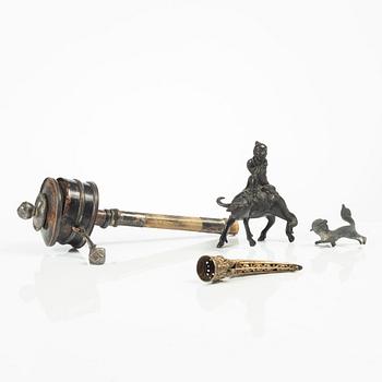 A group of two Chinese figures, a nail cover and a Tibetan prayer wheel, late Qing dynasty / early 20th century.