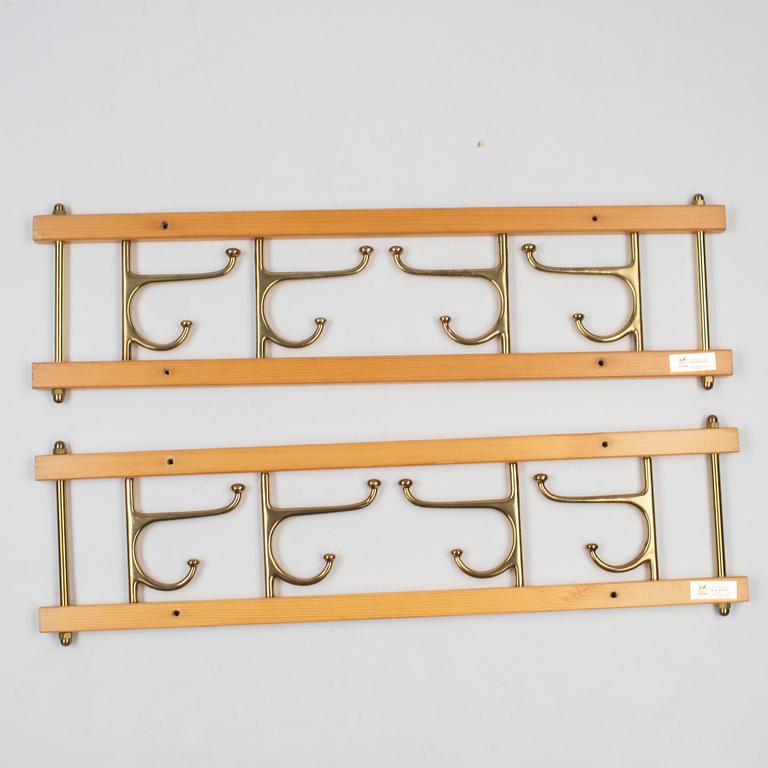 A pair of 'Dekorativ' coat hangers, Skoglunds metallgjuteri, Anderstorp, mid 20th Century.