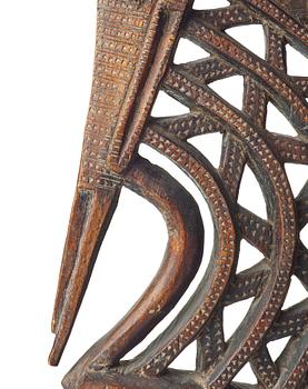 A SCULPTURE, a headdress, Tshiwara/Ciwara (stylized male antelope), wood, the Bambara tribe, Mali, h. 94 cm. On a base.