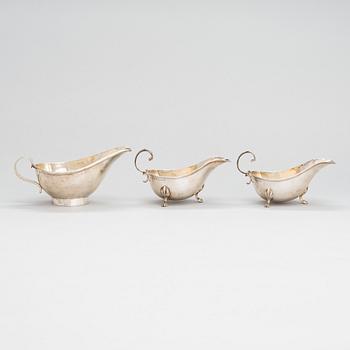 A pair of sauce jugs, maker's mark of Charles & George Asprey, London 1904, and 20th-century sauce jug. Sterling silver.