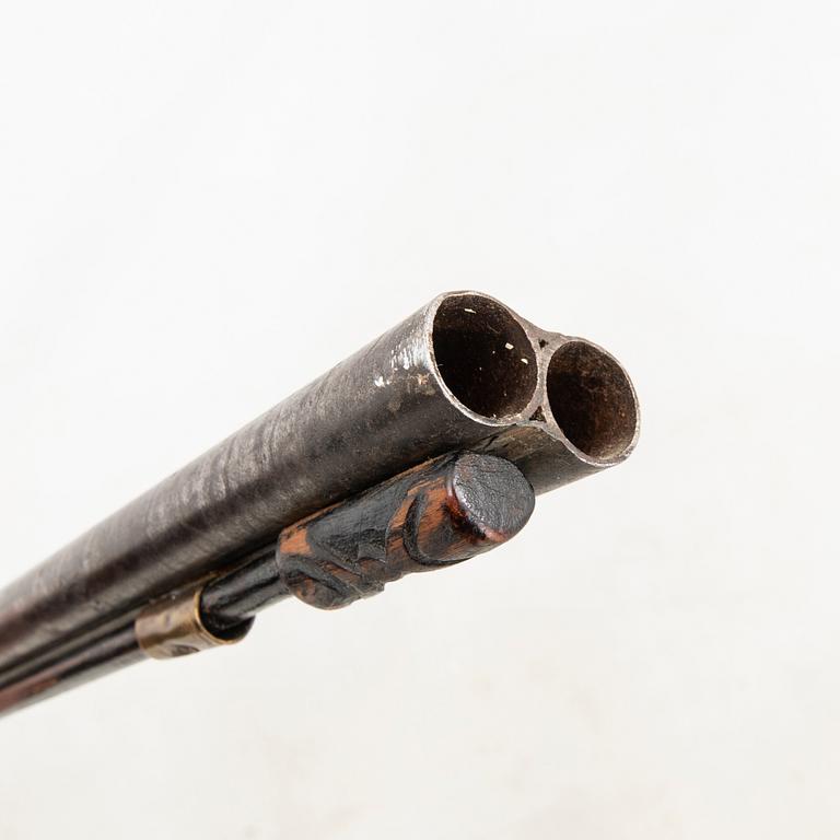 A double barreled percussion gun, 19th century.