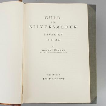 Three volumes of art and silver books.