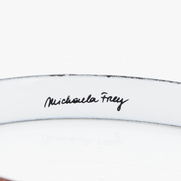 A bangle by Michaela Frey with multi-coloured enamel decoration.