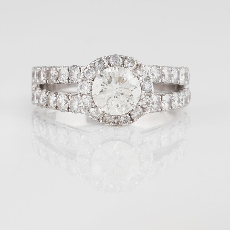 RING, 18K vitguld med briljantslipad diamant ca 0.80 ct samt små briljantslipade diamanter ca 6.30 ct. Vikt 6,3 gram.