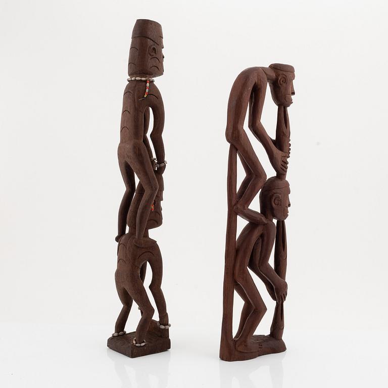 A group of three wooden Asmat sculptures, 20th Century.