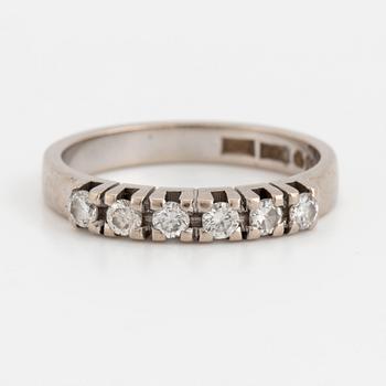 A ring set with six, round, brilliant-cut diamonds.