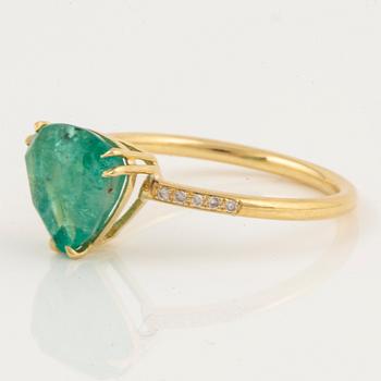 Triangle shaped emerald and brilliant-cut diamond ring.