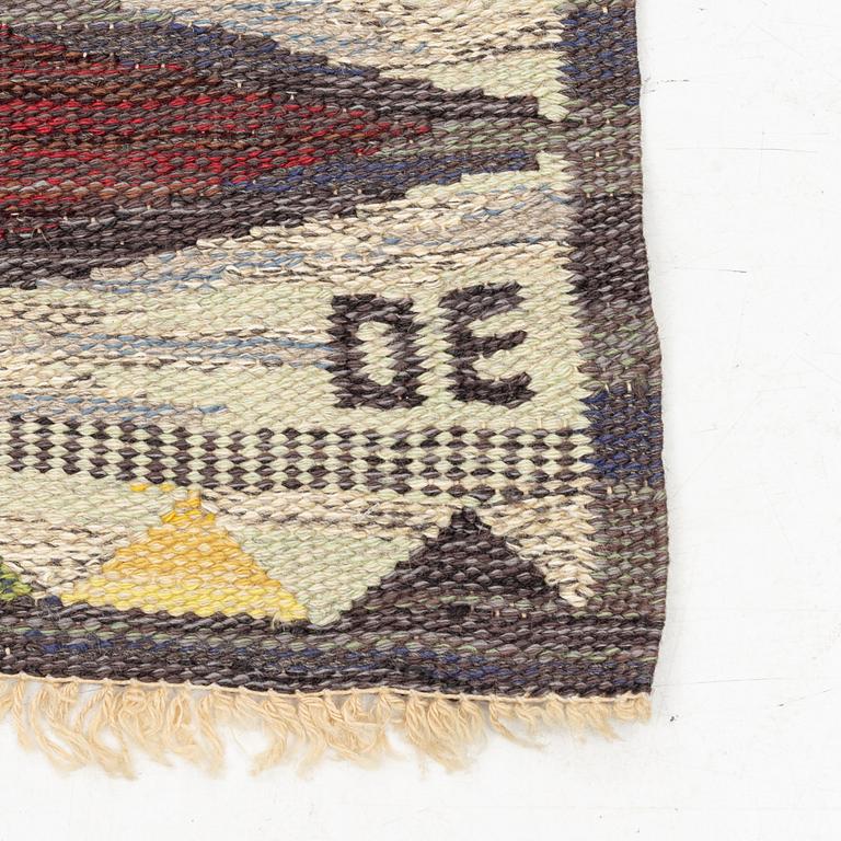 A flat weave runner, c 278 x 76 cm, signed DE.