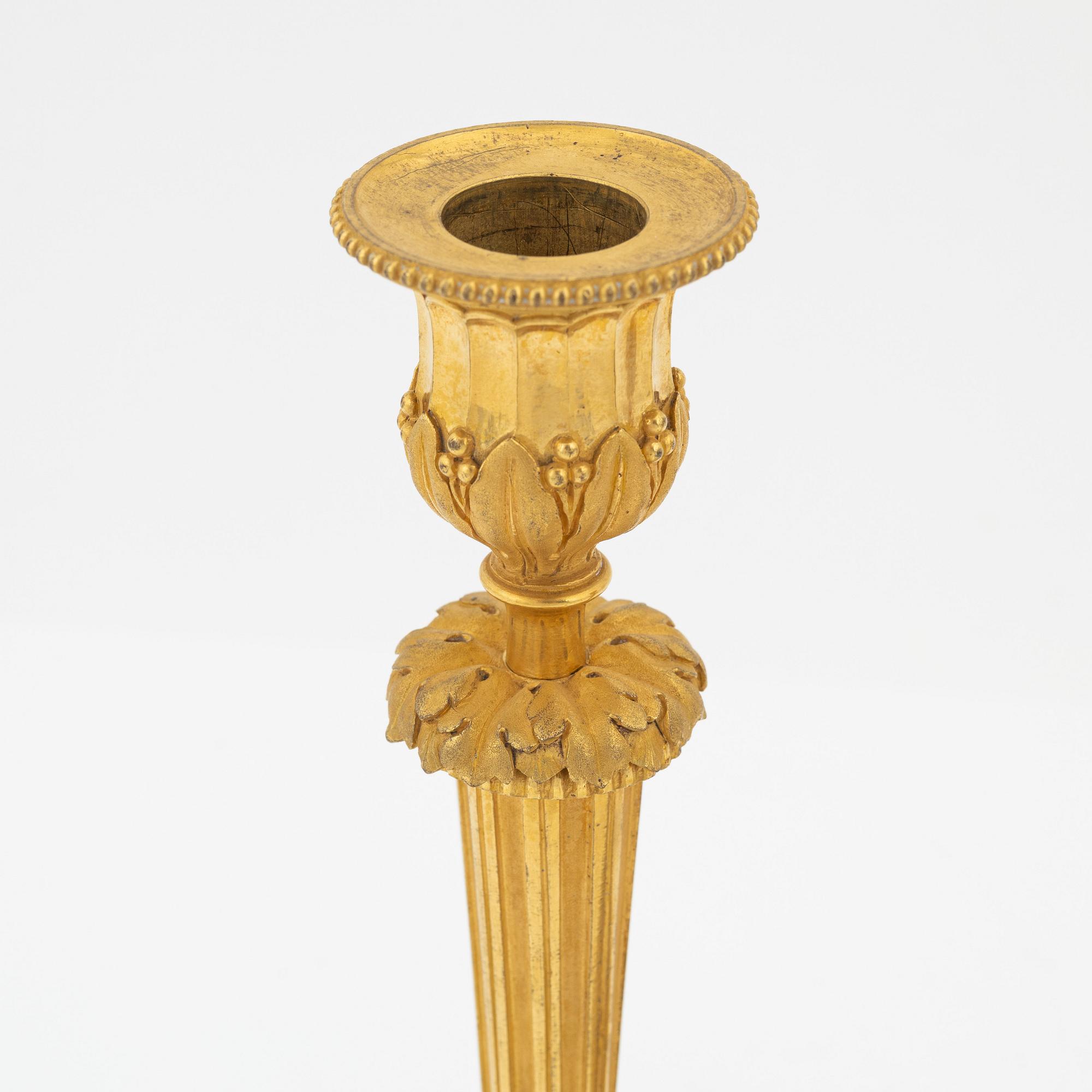 A pair of gilded bronze candelsticks, 19th Century.