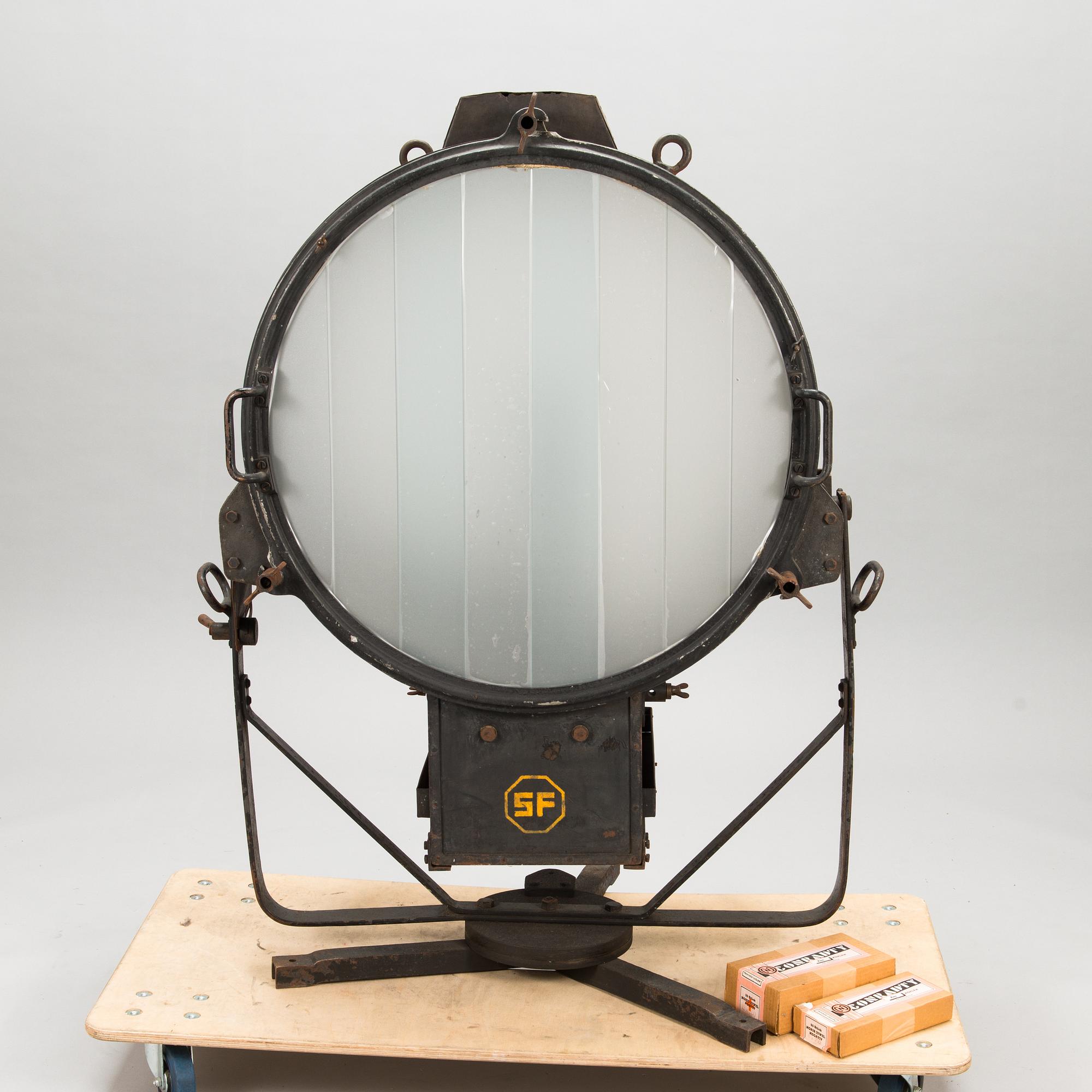 A film industry carbon arc spotlight with two boxes Kino-carbon sticks, + and -.