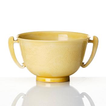An imperial yellow glazed two handled wine cup, Qing dynasty, Kangxi mark and of the period (1662-1722).