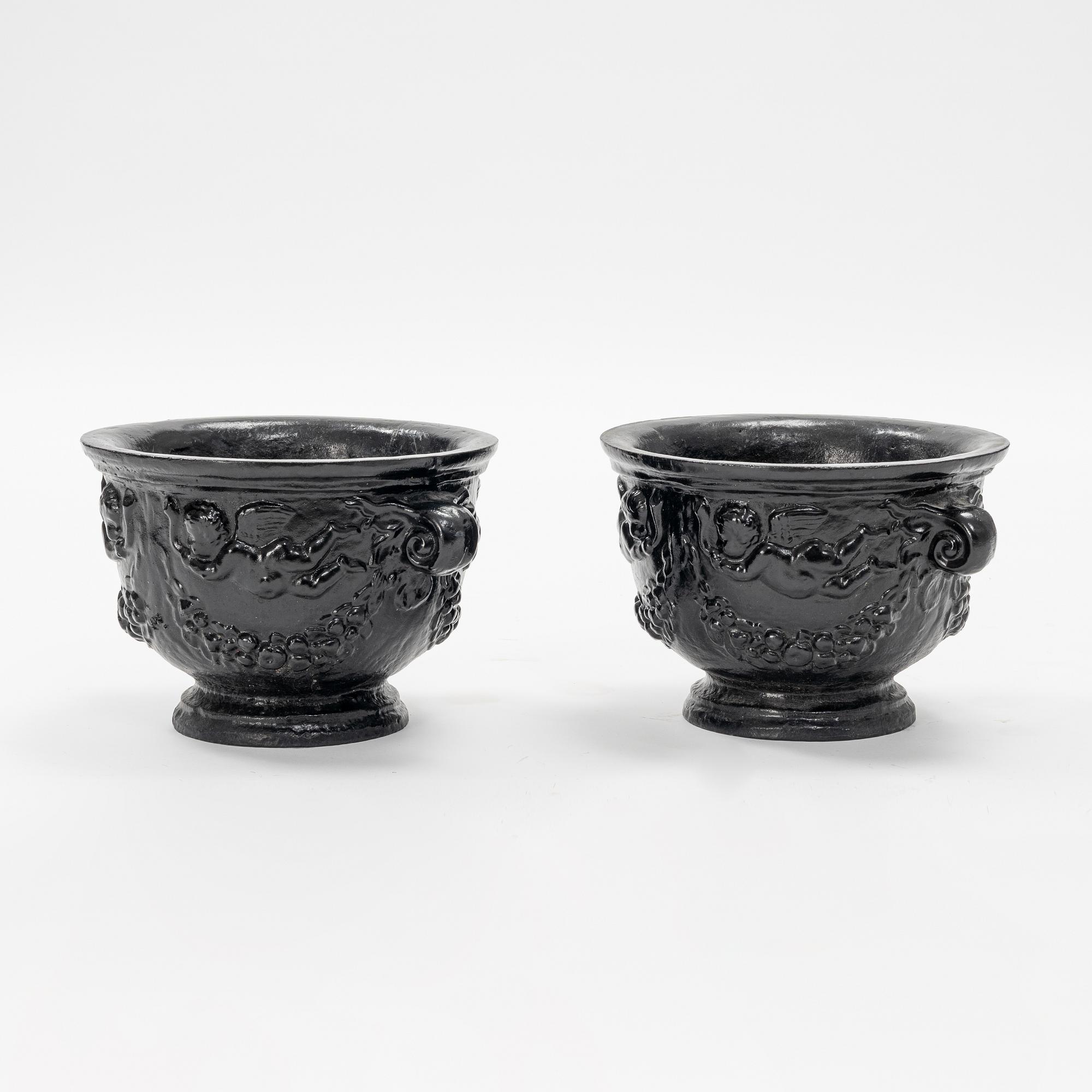 A pair of cast-iron urns.