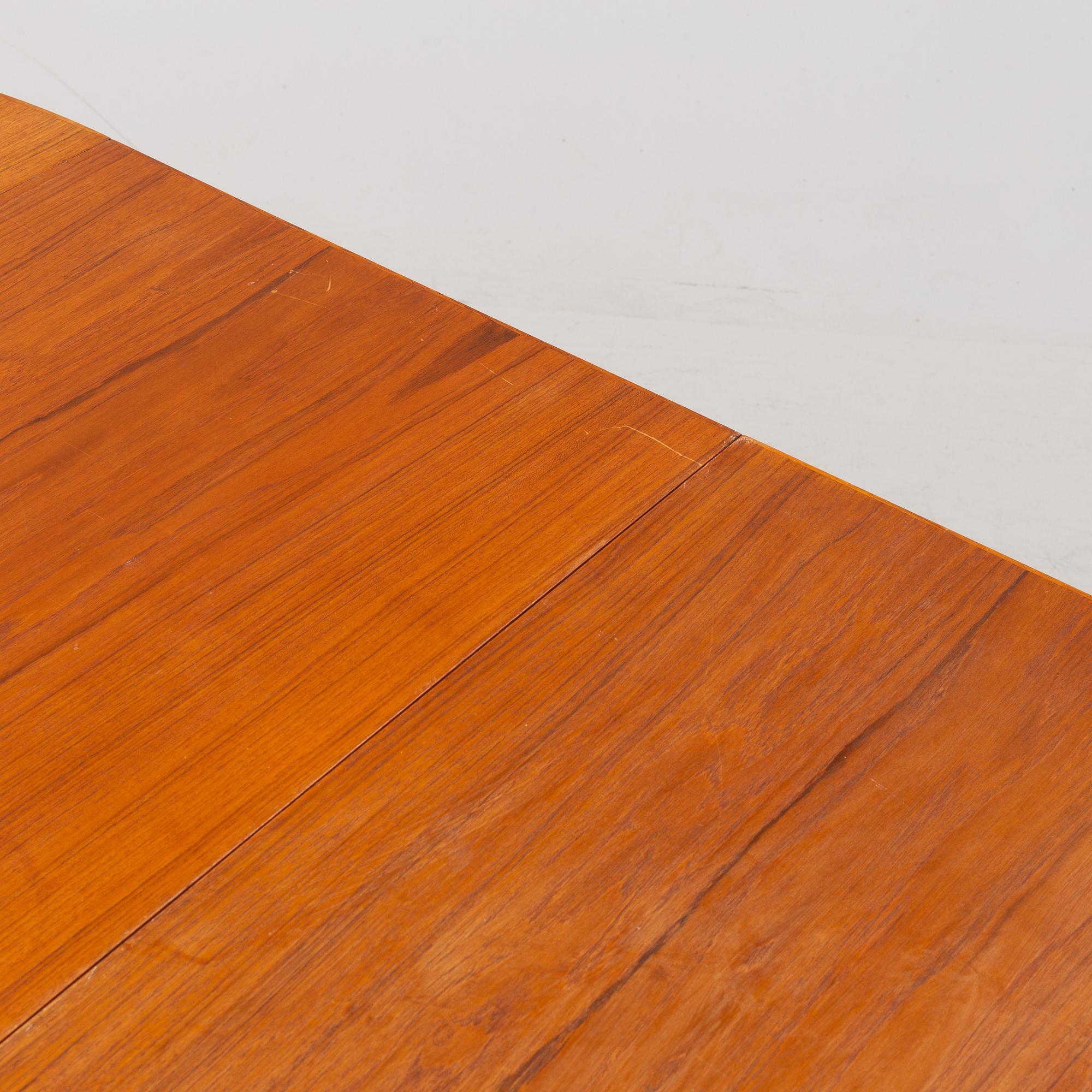 A 1950's/60's teak-veneered dining table.