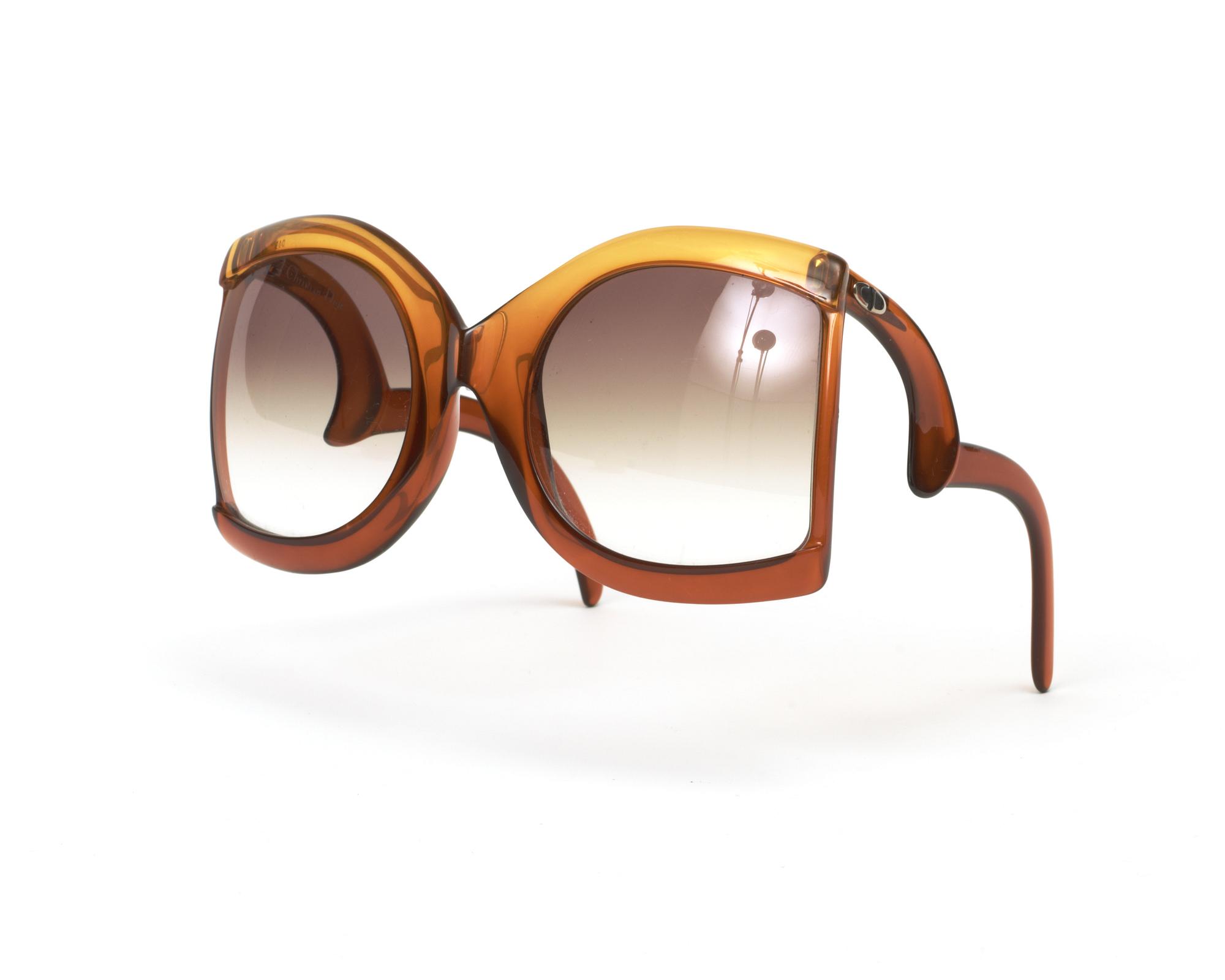 A clutch and sunglasses by Christian Dior.