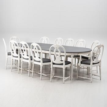 A dining table and twelve chairs, Gustavian style, second half of the 20th Century.