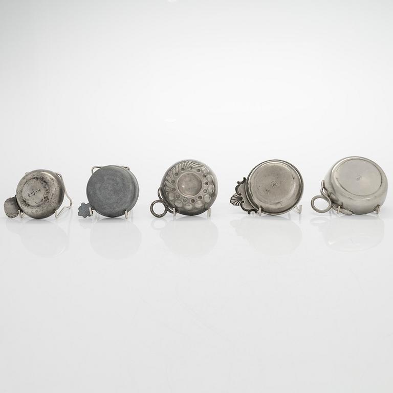 A set of fourteen tastevin cups, pewter and glass, 20th century.