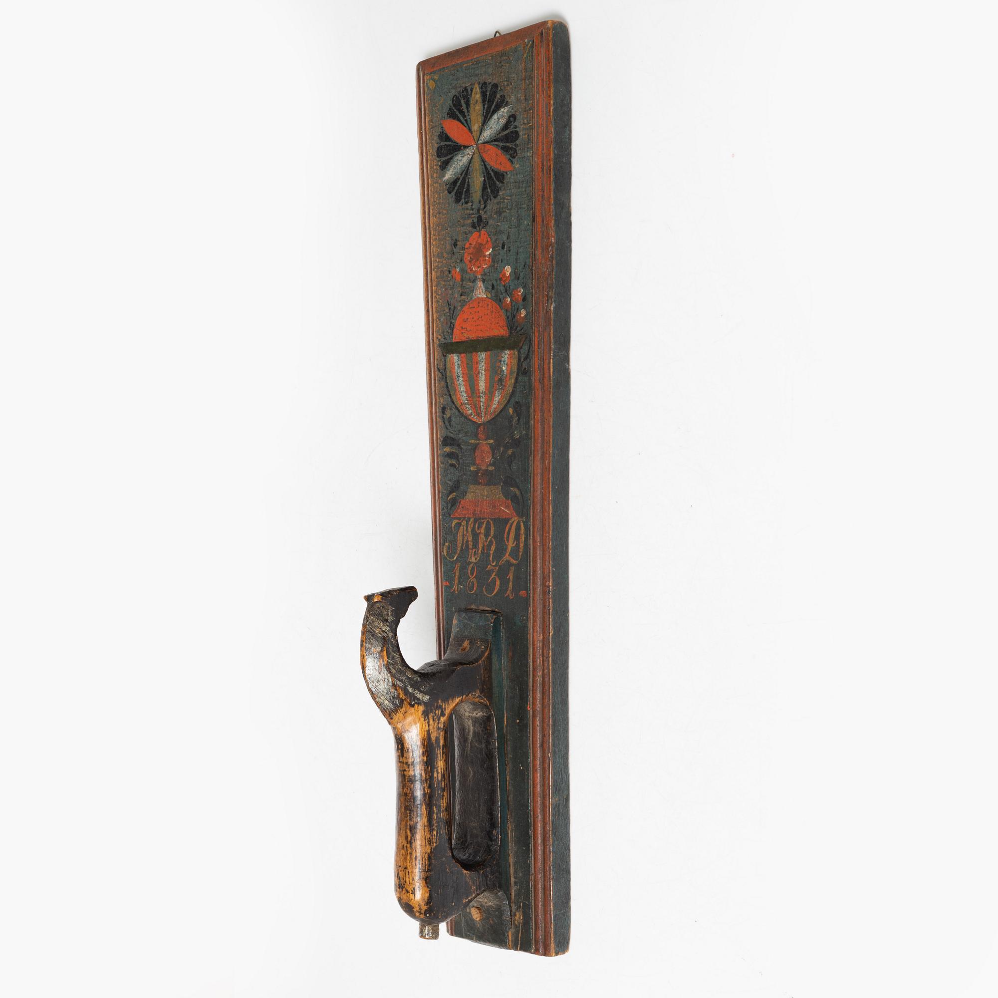 A painted wooden mangle board, dated 1831.
