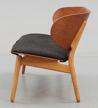 A Hans J Wegner teak and beech 'Shell' settee by Fritz Hansen, Denmark, 1950's.